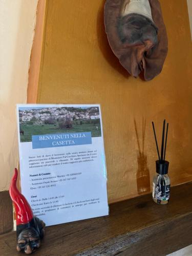 a sign on a shelf with a fish on a wall at La casetta - Casa vacanze in Montenero Val Cocchiara