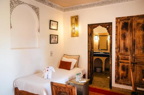 a bedroom with a bed and a mirror at Riad Anya & SPA in Marrakech