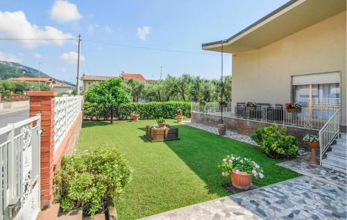 a backyard of a house with a yard of grass at Nice Home In Versilia in Vallecchia