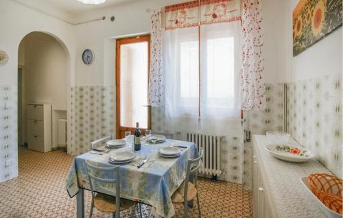 a dining room with a table with a blue table cloth at Nice Home In Versilia in Vallecchia