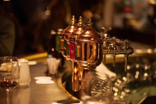 a row of bottles of wine on a bar with glasses at Tuc Blanc in Baqueira-Beret