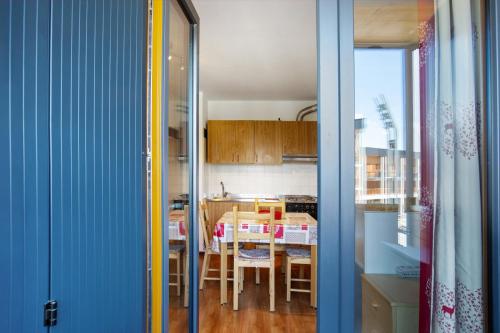 a kitchen with a table and a dining room at Sweet Home - Pila Appartamenti in Pila