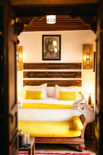a bedroom with two beds with yellow pillows at Riad Anya & SPA in Marrakech