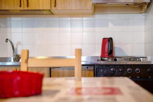 a kitchen with a table and a sink and a stove at Sweet Home - Pila Appartamenti in Pila