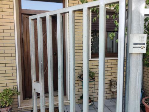 a porch with a white railing next to a door at Casa Etimo in Manduria
