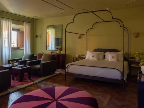 a bedroom with a bed and a living room at Palazzo Talìa - Small Luxury Hotels of the World in Rome