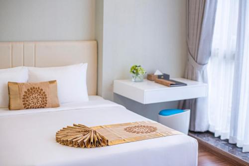 a bedroom with two beds and a window at Bridge Lakeside Room For Rent Hanoi in Hanoi