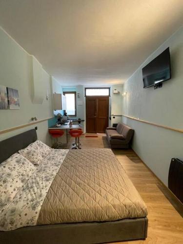 a bedroom with a bed and a living room at Perugia Home Apartment I Mille in Perugia