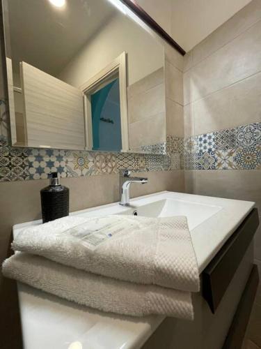 a bathroom with a white sink and a mirror at Perugia Home Apartment I Mille in Perugia