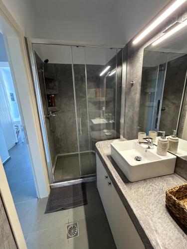 a bathroom with a sink and a shower at Thea Vouno Studios in Agia Pelagia Kythira