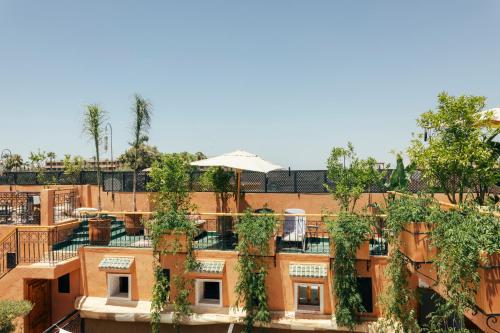 an apartment building with plants on the roof at Riad Anya & SPA in Marrakech