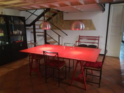 une table et des chaises rouges dans une pièce dans l'établissement Affreschi con vista Ducale, à Gênes