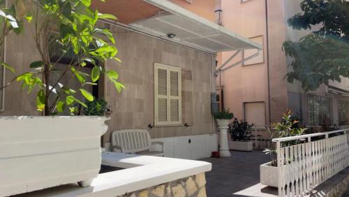 a patio with a table and chairs and a building at My Suite Fiuggi in Fiuggi
