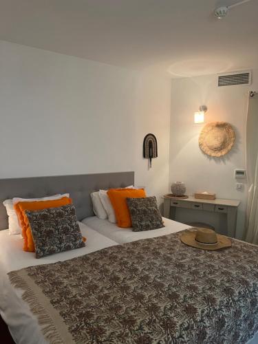 a bedroom with a bed with a hat on it at Maison du Lierre Bordeaux Centre ville in Bordeaux