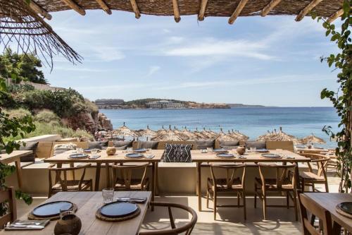a restaurant with tables and chairs and a view of the ocean at Hermes Riviera view in Athens