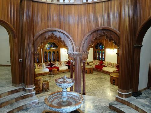 a living room with a fountain in the middle of it at Villa Cabo in Martil