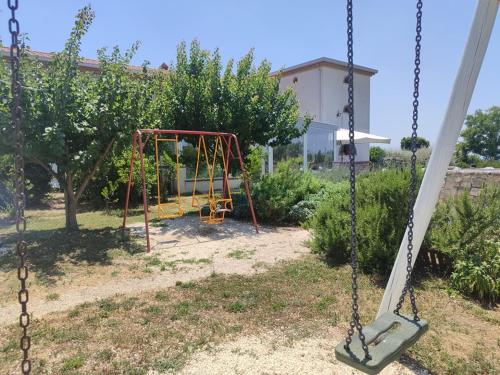 an empty swing set in a yard at Masseria Fontana dei Fieri in Pietrelcina