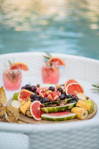 a plate of fruit and vegetables on a table at M&N Holiday Resort in Ulcinj