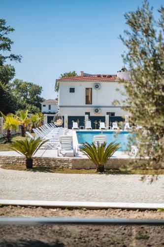 a house with a swimming pool in front of a house at M&N Holiday Resort in Ulcinj