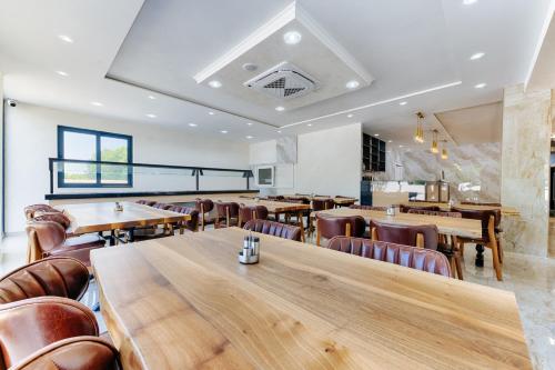 a dining room with wooden tables and chairs at M&N Holiday Resort in Ulcinj