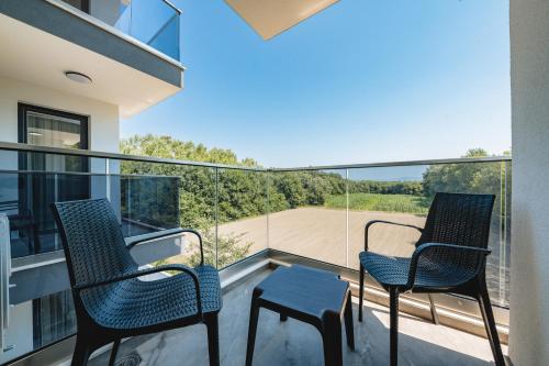 two chairs and a table on the balcony of a house at M&N Holiday Resort in Ulcinj