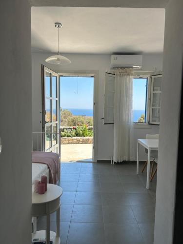 a bedroom with a bed and a view of the ocean at Thea Vouno Studios in Agia Pelagia Kythira