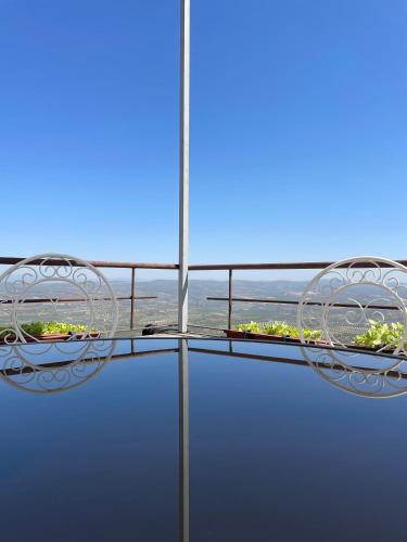 a balcony with two chairs and a view of the ocean at La Casa Escondida in Sabiote
