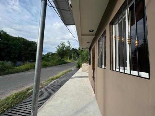 a building with a pole next to a street at Tiny Room El Mangal B&B in Suchitoto