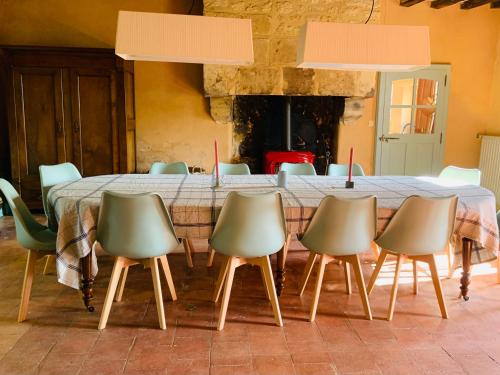 a table with six chairs and a large table with at La Breteche du Perche in Saint-Germain-de-la-Coudre
