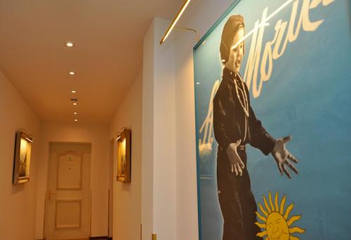 a mural of a man on a wall in a hallway at Soldanella in St. Moritz