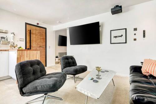 a living room with a couch and two chairs and a table at Aviator's Suite in Lakeway