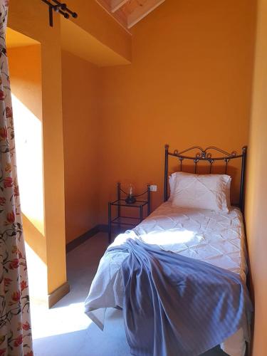 a bedroom with a bed in a room with a window at Calero II - Casas Rurales Los Calero in Vallehermoso