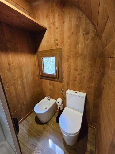 a small bathroom with a toilet and a sink at Vicolungo Glamour Lodge & SPA - Free SPA Hot Tub e Sauna in Vicolungo