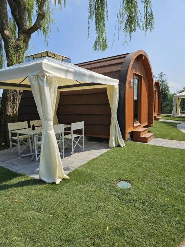 a white tent with tables and chairs in front of a building at Vicolungo Glamour Lodge & SPA - Free SPA Hot Tub e Sauna in Vicolungo