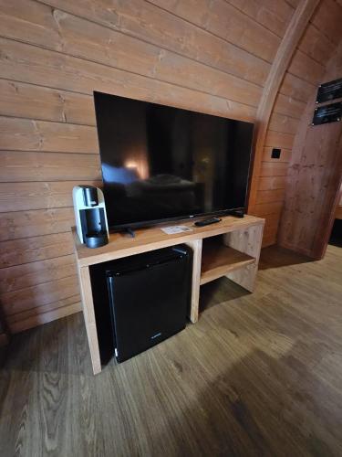 a living room with a large flat screen tv at Vicolungo Glamour Lodge & SPA - Free SPA Hot Tub e Sauna in Vicolungo