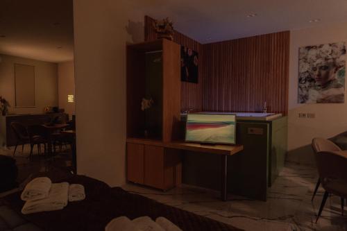 a hotel room with a desk with a laptop on it at Ortigia Sitari suites in Siracusa