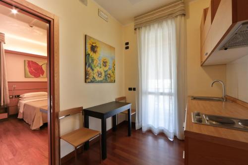 a room with a bed and a desk and a mirror at Best Western Hotel Dei Cavalieri in Barletta