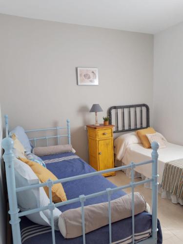 a bedroom with two bunk beds and a night stand at Villa Ariadna in Valentín