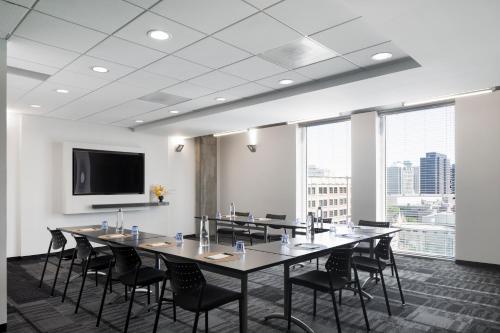 a conference room with a large table and chairs at Alt Hotel Winnipeg in Winnipeg