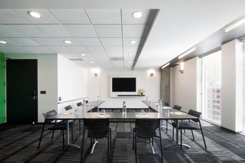 a conference room with a large table and chairs at Alt Hotel Winnipeg in Winnipeg