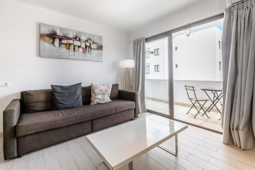 a living room with a couch and a table at Apartamentos Esmeralda Ibiza in Ibiza Town