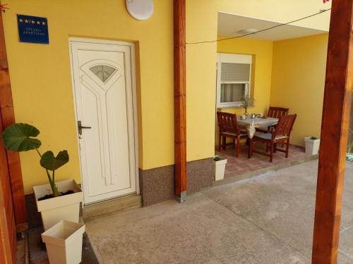 a room with a white door and a table at Maja in Kolan