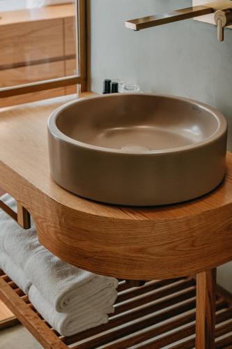 a sink on a wooden table in a bathroom at Casa das Lérias in Amarante