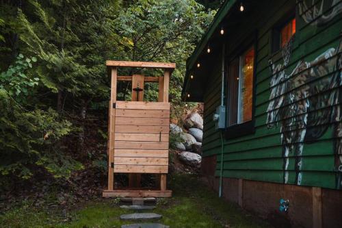 a wooden out door on the side of a house at Grinmore Lakehouse with Panoramic View & Hot Tub in Emsdale
