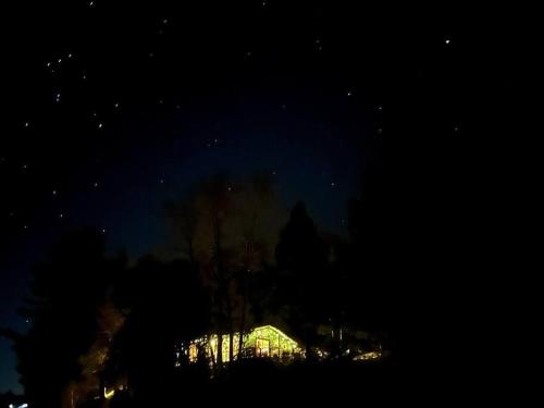 a night view of a building in the dark at Grinmore Lakehouse with Panoramic View & Hot Tub in Emsdale
