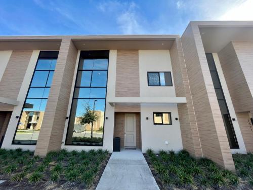 a rendering of a house with large windows at Luxury Home in Orlando with private Hot Tub - 7 Min from Disney Parks - 3 bedrooms and 4 bathrooms! in Orlando