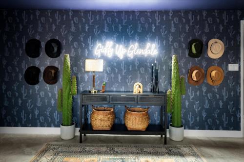a room with a fireplace with a blue wall with cactus at Basketball Court Heated Pool Mini Golf & More in Glendale