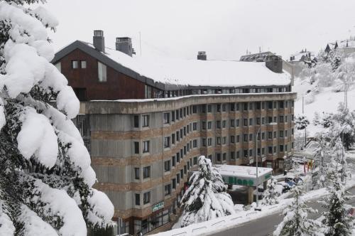 a building covered in snow with snow covered trees at Tuc Blanc in Baqueira-Beret