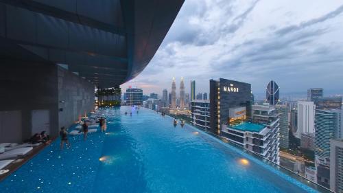 a swimming pool on top of a building with a city at Eaton Residence KLCC - JD HOME in Kuala Lumpur