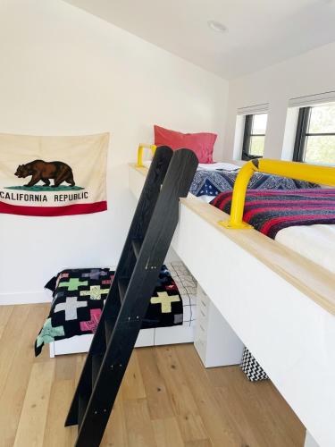 a bedroom with two bunk beds and a bed with avertisementforgrimgrim at Black Barn Ranch 25 Acres Wpool Near Downtown in San Luis Obispo
